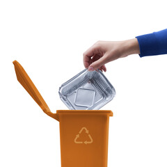 Woman putting an aluminum foil pan in the trash bin