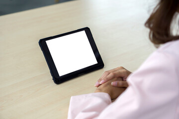 A woman confidently immersed in the virtual realm on tablet computer, seated at a contemporary table. Discover the wonders of modern technology, connectivity, and digital lifestyles.