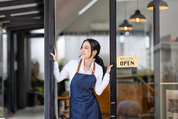 Startup successful small business owner sme beauty girl stand with tablet smartphone in coffee shop restaurant. Portrait of asian tan woman barista cafe owner. SME entrepreneur seller business concept