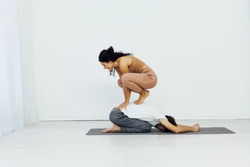 Fotobehang Exercises, meditation, asana, lotus pose, man and woman doing yoga © dmitriisimakov