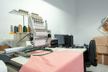 Close up of embroidery machine making patterns on textiles