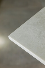 Close-up of a corner of light grey stone table top
