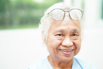 Asian senior woman wearing eyeglasses or vision glasses at home care service.