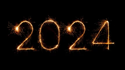 Fotobehang 2024 happy new year fireworks celebration written sparkling at night © geargodz