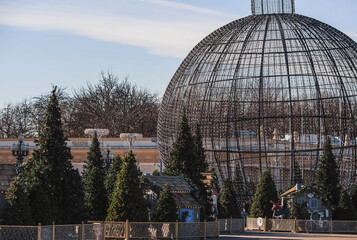Obraz premium New Year. Christmas decorations on the streets of Moscow 2024. Small houses, Christmas trees and a big ball. Christmas market in Gorky Park.