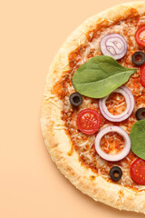 Tasty pizza with basil and tomatoes on beige background