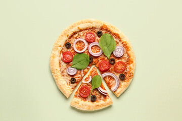 Tasty pizza with basil and tomatoes on green background