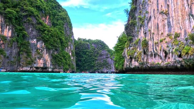 Phi Phi island off the coast of phuket thailand. Phi phi island is famous for turquoise clear blue waters teaming with Corel reef fish white soft sand and lush green trees.