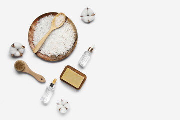 Composition with bath supplies and cotton flowers on white background
