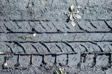 tire tracks in the mud on the ground