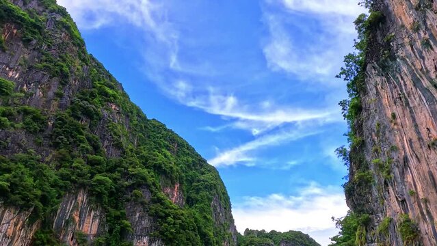 Phi Phi island off the coast of phuket thailand. Phi phi island is famous for turquoise clear blue waters teaming with Corel reef fish white soft sand and lush green trees.