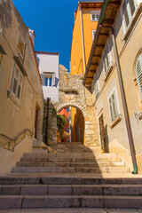 Fototapeta na wymiar A quiet back street with steps in the historic centre of the medieval coastal town of Rovinj in Istria, Croatia