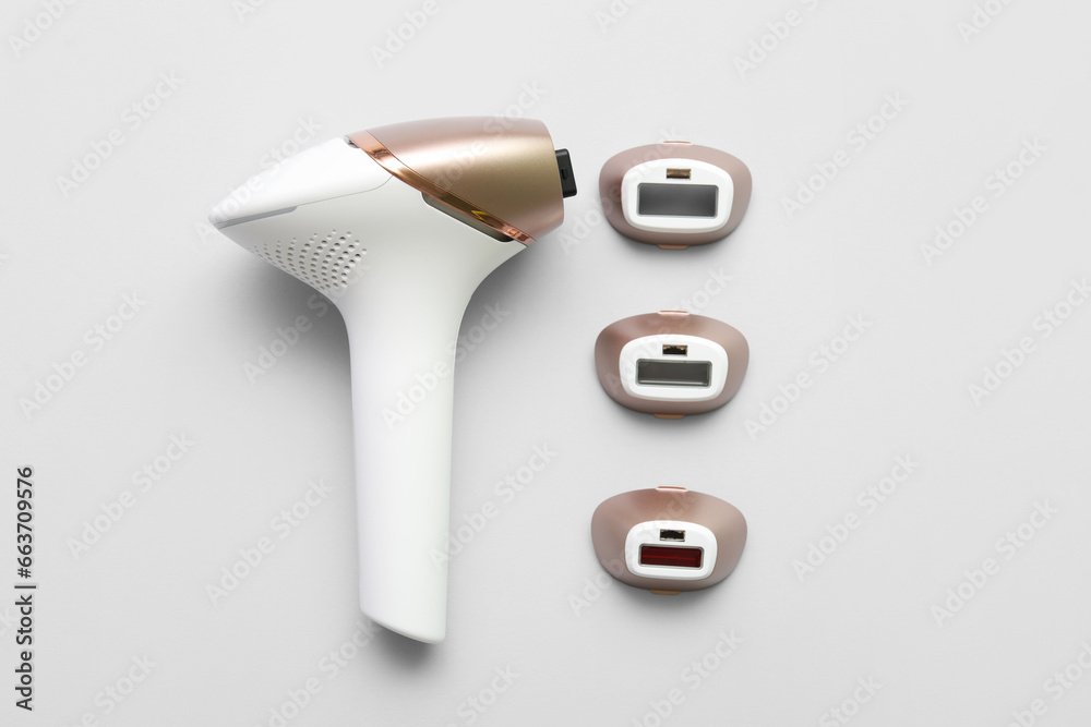 Wall mural Modern photoepilator with attachments on grey background