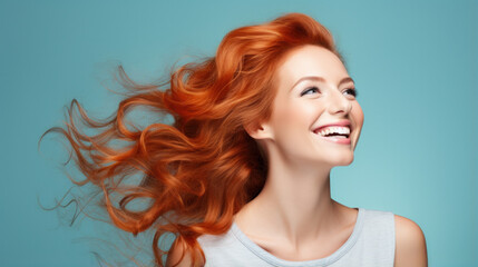 Fototapeta premium Ginger woman in casual clothing with copy space. Beautiful positive red hair woman standing against blue background