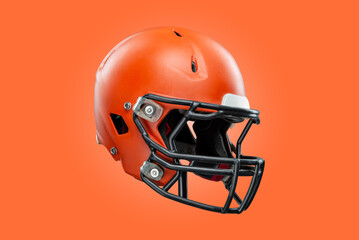 American football helmet on orange background