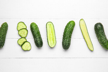 Fresh cucumbers on white wooden background