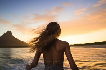 Fototapeta na wymiar Rear view of a beautiful young woman with long hair flying in the air and enjoying the sunset on the beach, Female surfer rear view in sea at sunset, Oahu, Hawaii, United States, AI Generated