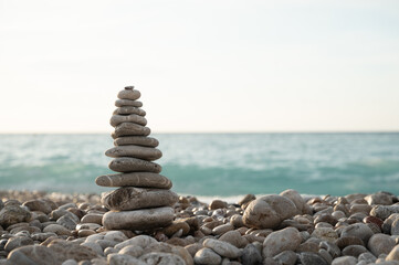 Balancing stone pyramid on the sea shore. Pebbles stone tower
