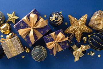 Lustrous Christmas Splendor: Top view picture of gleaming gold and blue-wrapped boxes, ornaments,...