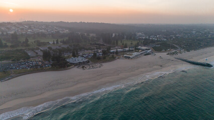 Aerial drone landscapes at sunrise over City beach in Perth with the city skyline in the background