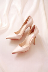 Elegant high heels in a close-up fashion scene, showcasing feminine glamour and beauty in a neutral setting.