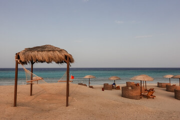 cozy hammock with a reed roof at the top of a sandy beach at the red sea