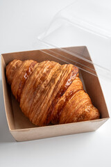 Delicious lush croissant in a lunch box close-up