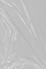 Crumpled plastic warp. Grunge plastic wrap on white background. Texture transparent stretched film polyethylene