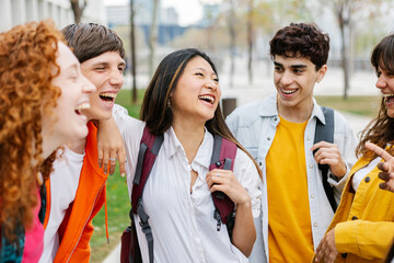 Community group of young college student friends laughing together at campus. Education lifestyle...