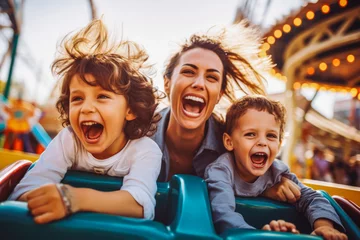 Cercles muraux Parc dattractions Mother and two children riding a roller coaster together having fun. Happy family on a fun roller coaster ride in an amusement park. Laughing.