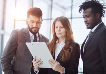 Diverse staff members confident smile business team holding document notepad device