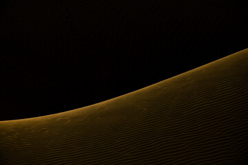 Artistic representation of dunes by using natural light falling on to edge of a parabolic sand dune