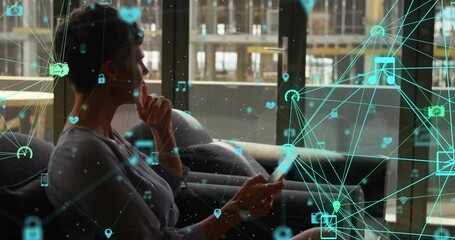 Animation of connected icons globes, thoughtful caucasian woman typing on smartphone - Powered by Adobe