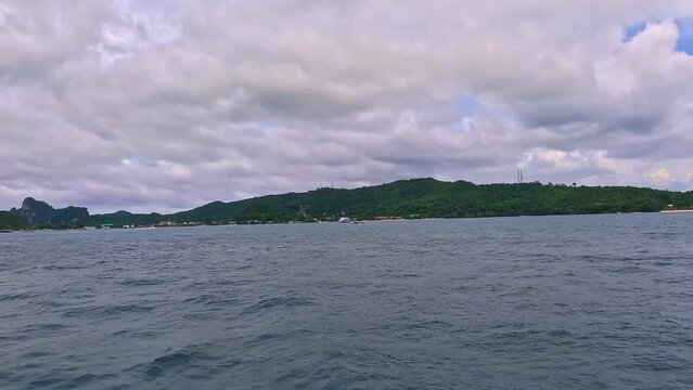 Phi Phi island off the coast of phuket thailand. Phi phi island is famous for turquoise clear blue waters teaming with Corel reef fish white soft sand and lush green trees.