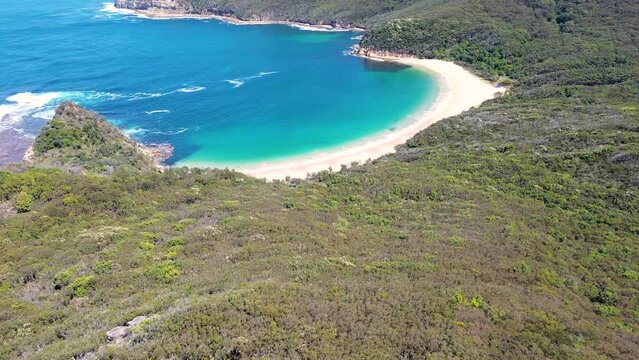 Drone aerial landscape bushland view of ocean beach trees Maitland Bay Bouddi National Park Central Coast NSW travel tourism holiday spot Australia 4K