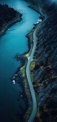 Aerial view of the road along the river in autumn mountain landscape