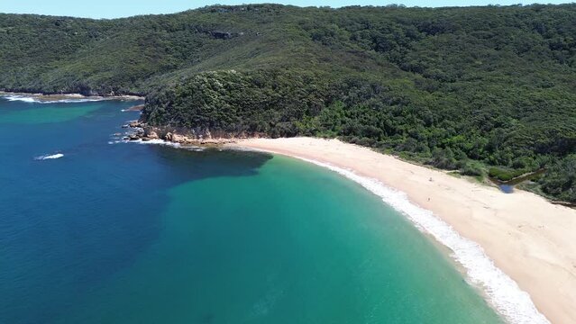 Drone aerial shot of Maitland Bay Bouddi National Park bushaldn coastline ocean beach swimming holiday spot tourism travel NSW Central Coast Australia 4K