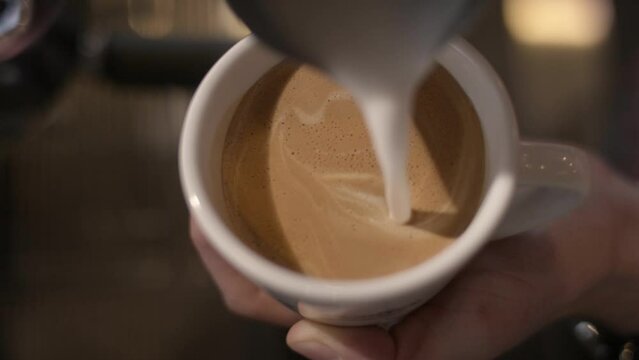 Cream is used to make an image in a cup of espresso