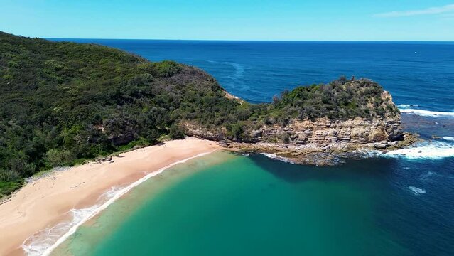 Drone aerial landscape shot of bushland cliff headland coastline Maitland Bay walking track beach ocean sea travel tourism NSW Central Coast Australia 4K