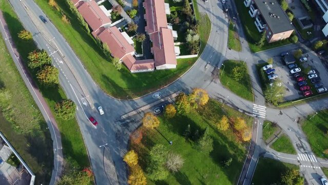 Aerial tracks cars driving on picturesque city streets in Finland