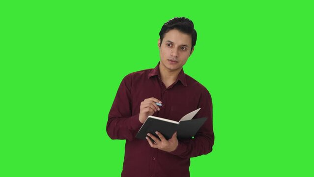 Indian teacher taking attendance in class Green screen