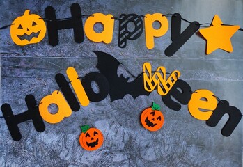 The inscription Happy Halloween on a dark background, decoration for the Halloween holiday....