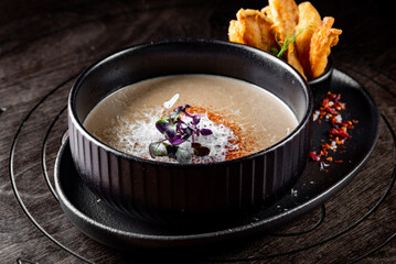 mushroom cream soup in bowl on wooden background