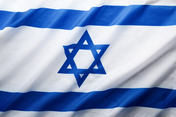 Israel flag. Independence Day of Israel. Israel flag beautifully waving wave with star of David over white wooden background. National pride of Israel. Patriotism and commonwealth. Top view. Mock up.