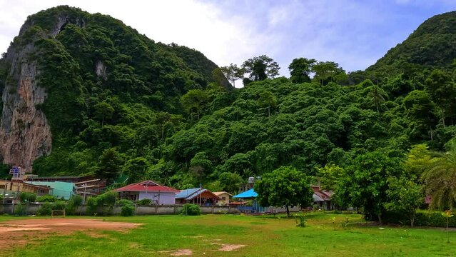 Phi Phi island off the coast of phuket thailand. Phi phi island is famous for turquoise clear blue waters teaming with Corel reef fish white soft sand and lush green trees.