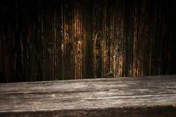 image of a wooden table on an abstract dark background with light in the center