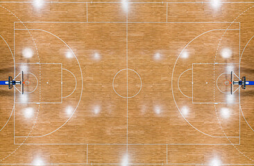 Top view of a parquet basketball court with hoops installed and reflections from lighting
