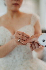 During a wedding, the bride and groom exchange wedding rings. Hand close-up
