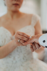 During a wedding, the bride and groom exchange wedding rings. Hand close-up