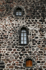 Windows in the stone wall of the castle, vertical picture